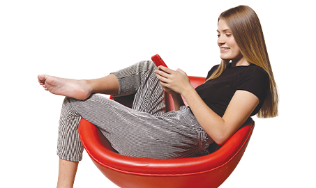 girl in red chair on cell phone